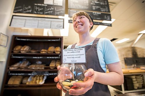 MIKAELA MACKENZIE / WINNIPEG FREE PRESS

Employee Jessie Dyck shows off the pay-it-forward button jar at Hildegards Bakery in Winnipeg on Friday, Jan. 24, 2020. For Maggie Macintosh story.
Winnipeg Free Press 2019.