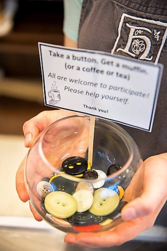 MIKAELA MACKENZIE / WINNIPEG FREE PRESS

Employee Jessie Dyck shows off the pay-it-forward button jar at Hildegards Bakery in Winnipeg on Friday, Jan. 24, 2020. For Maggie Macintosh story.
Winnipeg Free Press 2019.