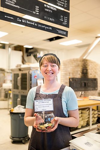 MIKAELA MACKENZIE / WINNIPEG FREE PRESS

Employee Jessie Dyck shows off the pay-it-forward button jar at Hildegards Bakery in Winnipeg on Friday, Jan. 24, 2020. For Maggie Macintosh story.
Winnipeg Free Press 2019.