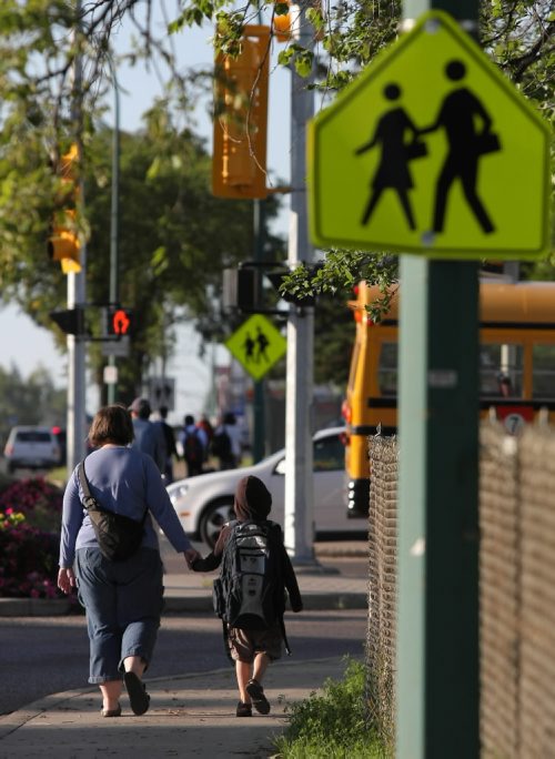 Brandon Sun A mother walks her son to school along 18th Street for the first day back to school at Earl Oxford on Wednesday morning. (Bruce Bumstead/Brandon Sun)