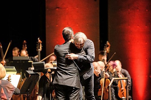 Mike Sudoma / Winnipeg Free Press
Composer, Harry Stafylakis, gets a hug from WSO Conductor, Daniel Raiskin after introducing his piece Sun Exhaling Light to the audience during Winnipeg New Music Festivals Fire and Blood showcase Saturday night at Centennial Concert Hall.
January 25, 2020