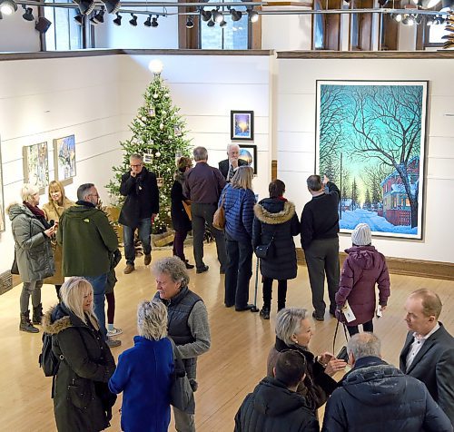 JASON HALSTEAD / WINNIPEG FREE PRESS

Attendees check out Wilf Perreault's painting There is Light on the Horizon at the annual Christmas Open House at the opening of Mayberry Fine Arts James and Barbara Burns Art Collection Exhibition and Sale in support of the CancerCare Manitoba Foundation and launch of the annual holiday open house exhibition at its Exhange District gallery on Dec. 8, 2019. (See Social Page)