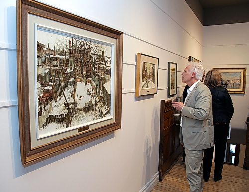 JASON HALSTEAD / WINNIPEG FREE PRESS

John Webster checks out the painting The Skating at Our Place (Winter in Days Gone By) by John Geoffrey Caruthers Little (left) and other works on display at the opening of Mayberry Fine Arts James and Barbara Burns Art Collection Exhibition and Sale in support of the CancerCare Manitoba Foundation and launch of the annual holiday open house exhibition at its Exhange District gallery on Dec. 8, 2019. (See Social Page)