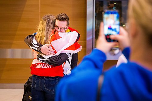 MIKAELA MACKENZIE / WINNIPEG FREE PRESS

Team Manitoba's men's skip Jacques Gauthier hugs his sister, Gaetanne Gauthier, as his mom, Cathy Gauthier, takes pictures at the airport in Winnipeg on Monday, Jan. 27, 2020. For Mike Sawatzky story.
Winnipeg Free Press 2019.