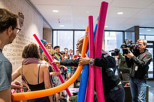 MIKAELA MACKENZIE / WINNIPEG FREE PRESS

A security guard takes pool noodles away from Budget for All Winnipeg members as they hold a "pool party" in protest of proposed budget cuts to city pools and recreation facilities in the lobby of City Hall in Winnipeg on Thursday, Jan. 30, 2020. For Danielle Da Silva story.
Winnipeg Free Press 2019.