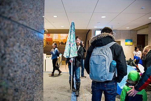 MIKAELA MACKENZIE / WINNIPEG FREE PRESS

Andrew Kohan, Budget for All Winnipeg member, carries a beach umbrella in the lobby of City Hall to protest proposed budget cuts to city pools and recreation facilities in Winnipeg on Thursday, Jan. 30, 2020. For Danielle Da Silva story.
Winnipeg Free Press 2019.