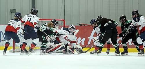 St.Mary's Academy Flames' goaltender Meagan Relf stops the puck with traffic in front of the net during their game against the Rocky Mountain Raiders' at the Female World Sport School Challenge hockey game at Iceplex, Thursday, January 30, 2020. (TREVOR HAGAN / WINNIPEG FREE PRESS)