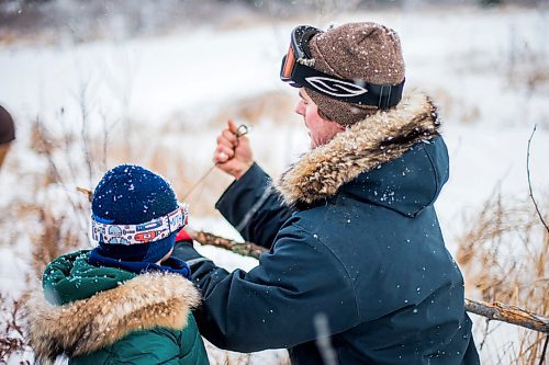 MIKAELA MACKENZIE / WINNIPEG FREE PRESS

Devin Imrie sets a new beaver trap as his five-year-old son, Thomas, watches on their trapline near Falcon Lake, Manitoba on Tuesday, Jan. 28, 2020. 
Winnipeg Free Press 2019.