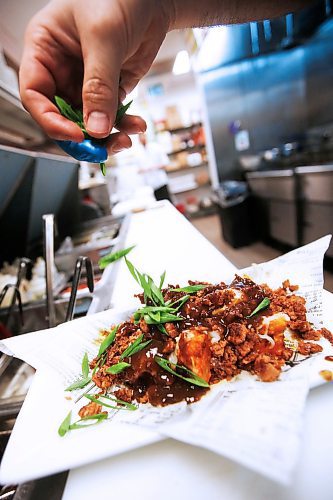 JOHN WOODS / WINNIPEG FREE PRESS
Cheeseburger Cauliflower Poutine, just one of the many plant based meat-like menu items at Fionn MacCools Crossroad and Grant Park restaurants, is prepared in the Winnipeg restaurant Thursday, January 30, 2020. 


Reporter: Scott-Reid