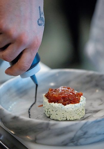 MIKE DEAL / WINNIPEG FREE PRESS
Gusto North in the Hargrave St. Market, 242 Hargrave, 2nd floor.
Jesse Friesen, Executive Chef with Academy Hospitality Co. prepares the Ricotta Della Piazza which contains San Mariano tomato jam, chili oil, pumpkin seeds, basil, and grilled sour dough.
200203 - Monday, February 03, 2020.