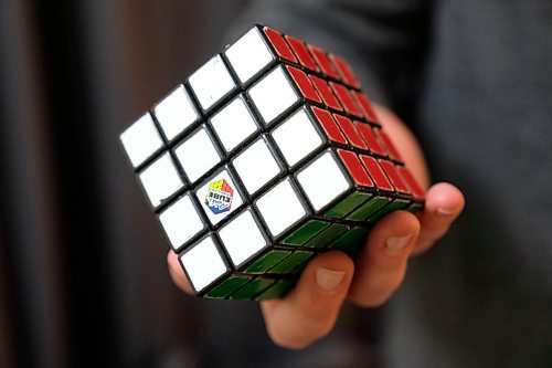 Daniel Crump / Winnipeg Free Press. John Hache holds the first 4x4x4 Rubiks cube he ever solved. February 3, 2020.