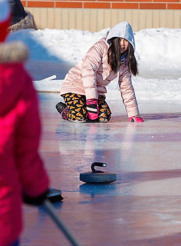 MIKE DEAL / WINNIPEG FREE PRESS
Irene N. throws a curling rock on a homemade curling rink during gym class behind Prince Edward School in River-East Transcona.
200204 - Tuesday, February 04, 2020.
