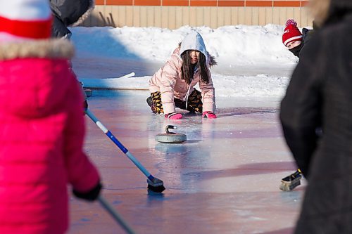 MIKE DEAL / WINNIPEG FREE PRESS
Irene N. throws a curling rock on a homemade curling rink during gym class behind Prince Edward School in River-East Transcona.
200204 - Tuesday, February 04, 2020.