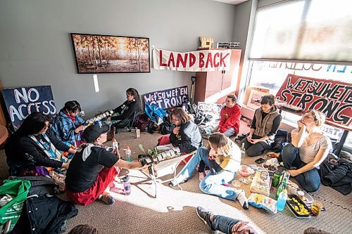 Mike Sudoma / Winnipeg Free Press
WetSuweten supporter, Carter Graveline (centre) talks on the phone with Minister of Northern Affairs, Dan Vandals office in Ottawa as they sit in at Vandals office in support of the WetSuwetEn peoples Tuesday afternoon.
February 4, 2020