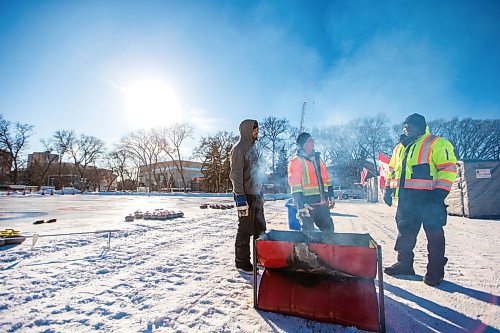 MIKAELA MACKENZIE / WINNIPEG FREE PRESS

Volunteers Brenday Bayne (left) and Mike Sokil and security Franklin Odidison stand around the fire after setting up for the Ironman Outdoor Curling Bonspiel in Memorial Park in Winnipeg on Friday, Feb. 7, 2020. 
Winnipeg Free Press 2019.