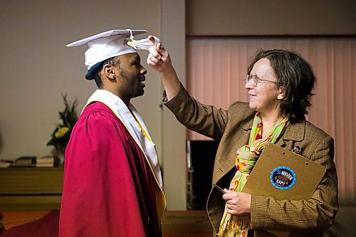 MIKAELA MACKENZIE / WINNIPEG FREE PRESS

Principal Francine Wiebe adjusts graduate Daniel Pembele's cap before the first-ever Freedom International School (a Christian private school for at-risk refugee students) graduation in Winnipeg on Friday, Feb. 7, 2020.  For Maggie Macintosh story.
Winnipeg Free Press 2019.