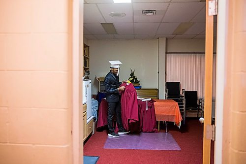 MIKAELA MACKENZIE / WINNIPEG FREE PRESS

Graduate Daniel Pembele gets his gown on before the first-ever Freedom International School (a Christian private school for at-risk refugee students) graduation in Winnipeg on Friday, Feb. 7, 2020.  For Maggie Macintosh story.
Winnipeg Free Press 2019.