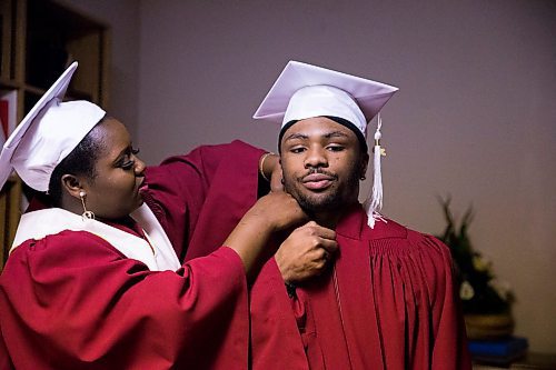 MIKAELA MACKENZIE / WINNIPEG FREE PRESS

Devotha Kwizera helps Daniel Pembele gets his gown on before the first-ever Freedom International School (a Christian private school for at-risk refugee students) graduation in Winnipeg on Friday, Feb. 7, 2020.  For Maggie Macintosh story.
Winnipeg Free Press 2019.