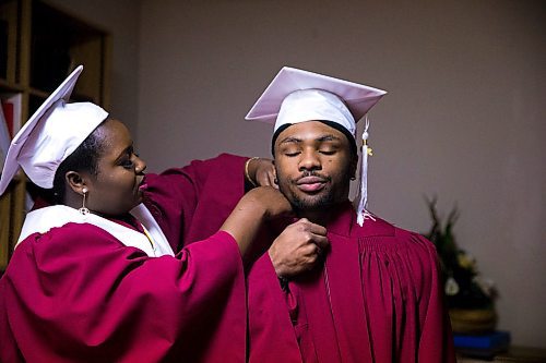 MIKAELA MACKENZIE / WINNIPEG FREE PRESS

Devotha Kwizera helps Daniel Pembele gets his gown on before the first-ever Freedom International School (a Christian private school for at-risk refugee students) graduation in Winnipeg on Friday, Feb. 7, 2020.  For Maggie Macintosh story.
Winnipeg Free Press 2019.