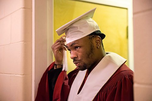 MIKAELA MACKENZIE / WINNIPEG FREE PRESS

Graduate Daniel Pembele adjusts his cap before the first-ever Freedom International School (a Christian private school for at-risk refugee students) graduation in Winnipeg on Friday, Feb. 7, 2020.  For Maggie Macintosh story.
Winnipeg Free Press 2019.