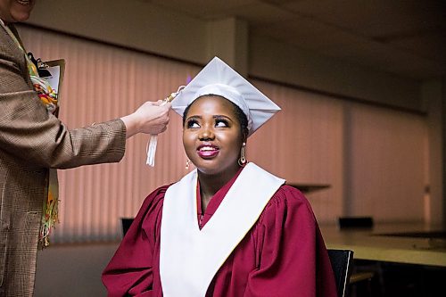 MIKAELA MACKENZIE / WINNIPEG FREE PRESS

Principal Francine Wiebe adjusts graduate Devotha Kwizera's cap before the first-ever Freedom International School (a Christian private school for at-risk refugee students) graduation in Winnipeg on Friday, Feb. 7, 2020.  For Maggie Macintosh story.
Winnipeg Free Press 2019.