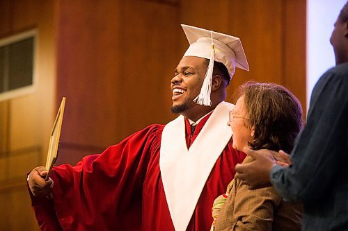 MIKAELA MACKENZIE / WINNIPEG FREE PRESS

Graduate Prince Busime laughs with principal Francine Wiebe as he receives his diploma at the first-ever Freedom International School (a Christian private school for at-risk refugee students) graduation in Winnipeg on Friday, Feb. 7, 2020.  For Maggie Macintosh story.
Winnipeg Free Press 2019.