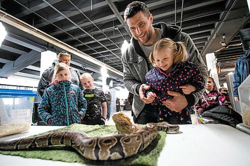 Daniel Crump / Winnipeg Free Press. Devin Church (right) holds his Two-year-old daughter Octavia Church (right) who reacts after touching a bearded dragon. The reptiles were on display Saturday afternoon as part of Love Your Pet Day at Assiniboia Downs. February 8 , 2020.