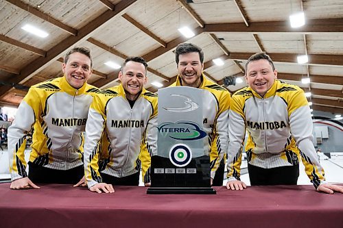 Daniel Crump / Winnipeg Free Press. Team Gunnlaugson pose for photos with the trophy while wearing Team Manitoba Jackets after winning 2020 Viterra Championship at Eric Coy Arena. February 9, 2020.