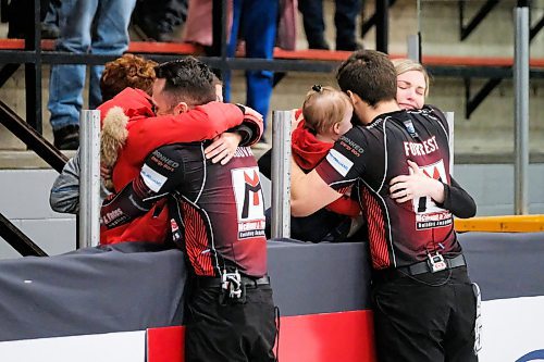 Daniel Crump / Winnipeg Free Press. Connor Njegovan (left) and Alex Forrest (right) receive hugs from supporters after winning the 2020 Viterra Championship at Eric Coy Arena. February 9, 2020.