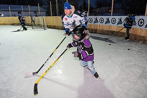 Daniel Crump / Winnipeg Free Press. Moose winger Kristian Vesalainen races a young fan on the Glawson Familys backyard rink. February 10, 2020.