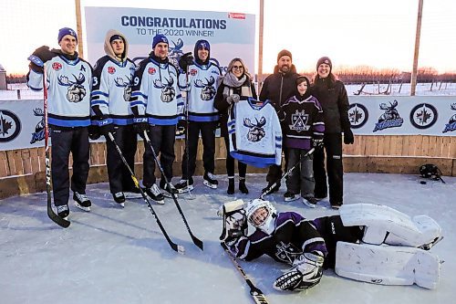 Daniel Crump / Winnipeg Free Press. Manitoba Moose Nelson Nogier, Kristian Vesalainen, David Gustafsson and Cole Maier (from left) pose for a photo as Raquel Payne presents the Glawson family with a Manitoba Moose jersey signed by the team. February 10, 2020.