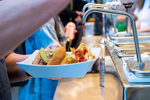 MIKAELA MACKENZIE / WINNIPEG FREE PRESS

A customer puts ketchup on their fries at Wienerpeg, the new gourmet hot dog vendor at The Forks, in Winnipeg on Tuesday, Feb. 11, 2020. For biz story.
Winnipeg Free Press 2019.