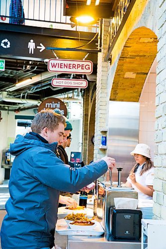 MIKAELA MACKENZIE / WINNIPEG FREE PRESS

Chris Stammers gets condiments at Wienerpeg, the new gourmet hot dog vendor at The Forks, in Winnipeg on Tuesday, Feb. 11, 2020. For biz story.
Winnipeg Free Press 2019.