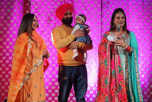 JASON HALSTEAD / WINNIPEG FREE PRESS

L-R: Charan Aulakh and Chandan Aulakh with their four-month-old daughter Kudrat (four months old) with Gaganpreet Sidhu on stage at the Lohri Mela celebration at the RBC Convention Centre Winnipeg on Jan. 11, 2020. (See Social Page)