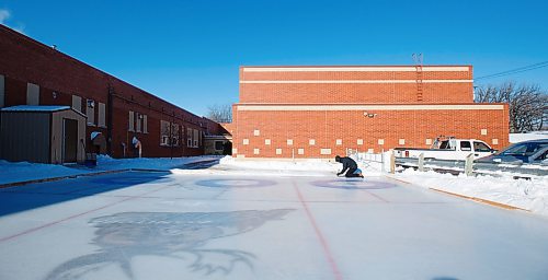 MIKE DEAL / WINNIPEG FREE PRESS
Phys Ed teacher Tyler McGurryhe cleans out the hack prior to gym class on the homemade curling rink behind Prince Edward School in River-East Transcona Wednesday morning.
200213 - Thursday, February 13, 2020.