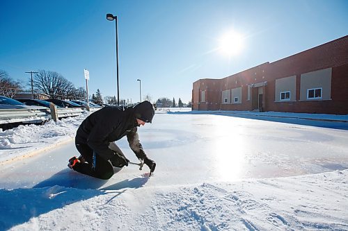 MIKE DEAL / WINNIPEG FREE PRESS
Phys Ed teacher Tyler McGurryhe cleans out the hack prior to gym class on the homemade curling rink behind Prince Edward School in River-East Transcona Wednesday morning.
200213 - Thursday, February 13, 2020.