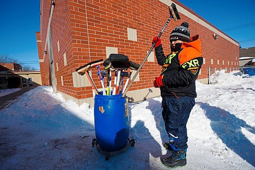 MIKE DEAL / WINNIPEG FREE PRESS
Doug grabs a broom before taking to the homemade curling rink behind Prince Edward School in River-East Transcona.
200213 - Thursday, February 13, 2020.