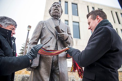 MIKAELA MACKENZIE / WINNIPEG FREE PRESS

Andrew Carrier, VP of the Winnipeg region of the MMF (left), and Brad Boudreau, chair of the MMF Bison Local, tie a sash around the Louis Riel statue at the University of Manitoba during on-campus Louis Riel Day celebrations in Winnipeg on Friday, Feb. 14, 2020. Standup.
Winnipeg Free Press 2019.