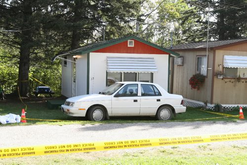 Brandon Sun 18092009 Police tape surrounds a section of cabins on First St. in the 'old campground' cabin section of Wasagaming during a police investigation surrounding a suspicious death on Friday morning. The investigation focused on the white cabin with the car parked in front. (Tim Smith/Brandon Sun)