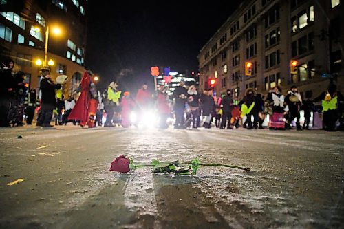 Daniel Crump / Winnipeg Free Press. A rose lays where it fell in the intersection of Memorial Blvd and Portage avenue as participants of the Annual Manitoba Womens Memorial March in honour of MMIWG & 2SLGBTQQIA perform a round dance. February 14, 2020.
