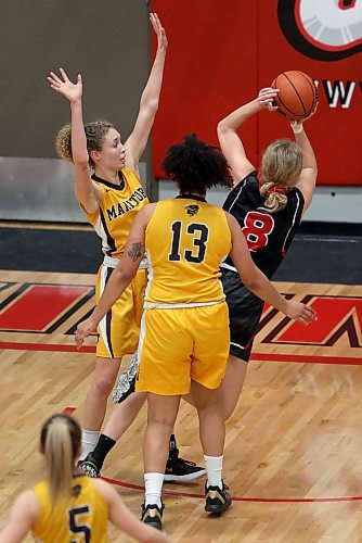 SHANNON VANRAES / WINNIPEG FREE PRESS
Mikayla Funk of the University of Winnipeg Wesmen controls the ball, as Addison Martin and Keziah Brothers of the University of Manitoba Bisons attempt to block her during a Canada West Play-In Game at the Duckworth Centre on February 14, 2020.