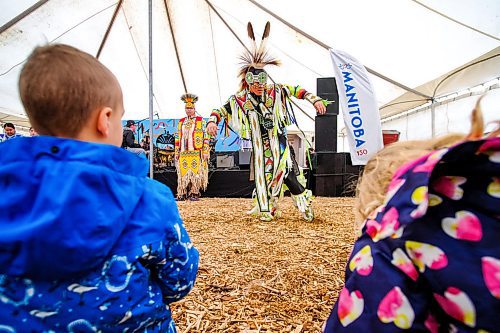 Daniel Crump / Winnipeg Free Press. Young visitors watch Grass Dancer Michael Esquah Jr. perform a dance during the first Saturday of Festival du Voyageur. February 15, 2020.