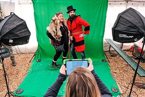 Daniel Crump / Winnipeg Free Press. Shaneen Robinson- Desjarlais (left) and Jacques Richer (right) have free photos taken in period dress at the Parks Canada photo booth. February 15, 2020.