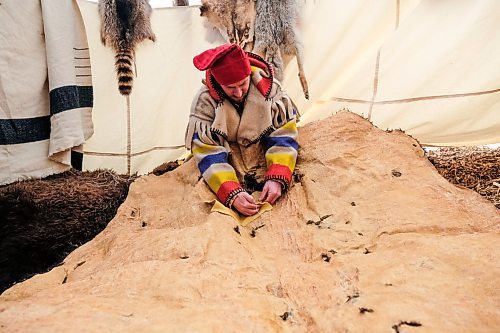 Daniel Crump / Winnipeg Free Press. Robert Gendron works at patching holes in his bison blanket as part of a traditional display at Festival duVoyageur. February 15, 2020.
