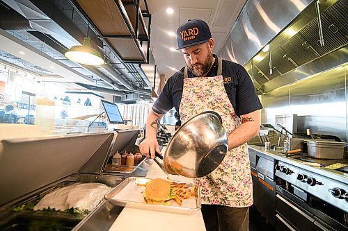 Mike Sudoma / Winnipeg Free Press
Yard Sale/Good Fight Tacos Kitchen Manager, Steven Toews doles out some fries to go along with the 342 Burger inside the join restaurant Sunday afternoon inside of Hargrave Market.
February 16, 2020