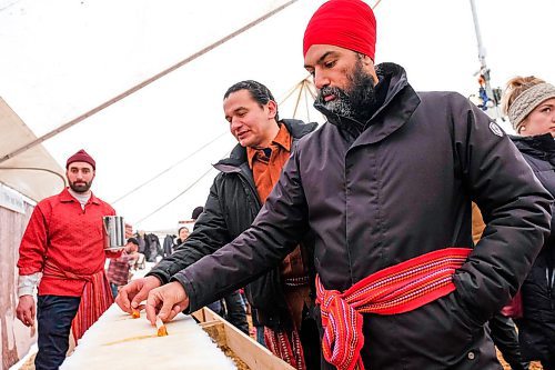 Daniel Crump / Winnipeg Free Press. NDP Leader Jagmeet Singh (right) and Manitoba NDP Leader Wab Kinew (left) try maple syrup treats at Festival du Voyageur to celebrate Louis Riel Day. February 17, 2020.