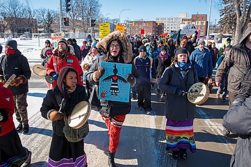 MIKE DEAL / WINNIPEG FREE PRESS
Holding a sign that says, "Water is life," Brielle Beardy-Linklate, a local activist, walks with drummers during a walk organized by the Wilderness Committee over the lunch hour from the Manitoba Legislative building to the Law Courts building and back in support of the Wetsuweten Hereditary Chiefs who are being forcibly removed from their territory for a fossil fuel project. 
200218 - Tuesday, February 18, 2020.