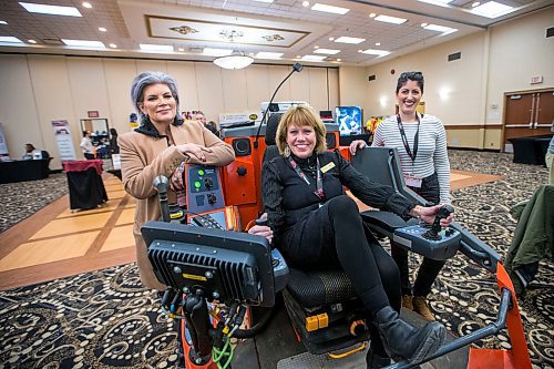 MIKAELA MACKENZIE / WINNIPEG FREE PRESS

Muriel Torchia Shyjak, owner of MG Electrical/Mechanical Services (left), Carol Paul, organizer of the event and head of the construction sector council, and Colleen Munro, head of Munro Construction pose for a portrait with a blast hole drilling simulator at the Women in Trades conference at Victoria Inn Hotel & Convention Centre in Winnipeg on Tuesday, Feb. 18, 2020. For Martin Cash story.
Winnipeg Free Press 2019.