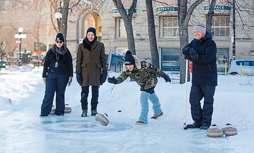 MIKE DEAL / WINNIPEG FREE PRESS
Amie Seier from Community Gym throws a rock at the Old Market Square curling rink during a friendly match over the noon-hour.
(l-r) Councillor Sherri Rollins,  Exchange District BIZ Executive Director David Pensato, Seier, and Mayor Brian Bowman.

Mayor Brian Bowman and councillors Vivian Santos, John Orlikow, and Sherri Rollins battled it out Canadian winter prairie style in a friendly curling match against Exchange District BIZ Executive Director David Pensato and local business owners Chris Graves of The Kings Head, Amie Seier of Community Gym and Greg Tonn, owner of Into the Music, at the Old Market Square community rink.
200219 - Wednesday, February 19, 2020.