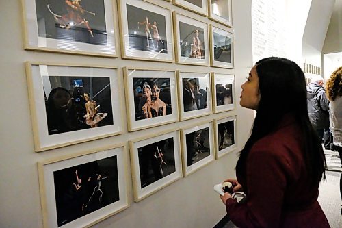 Daniel Crump / Winnipeg Free Press. Isabelle Ly looks at still photographs from the RWB 81st season video shoot on display in the RWB building atrium after the RWB 81st season launch. February 19, 2020.